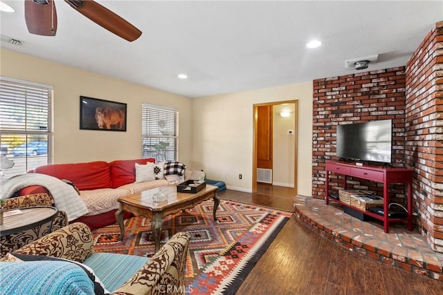 living room featuring ceiling fan and dark hardwood / wood-style flooring