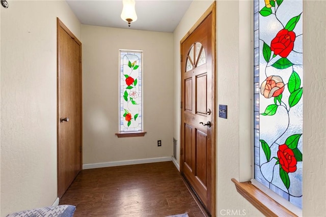 doorway with dark wood-type flooring