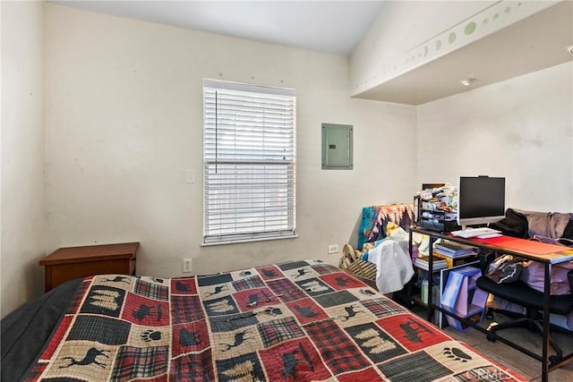 bedroom with electric panel and lofted ceiling