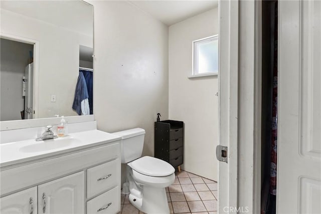 bathroom with tile patterned floors, vanity, and toilet