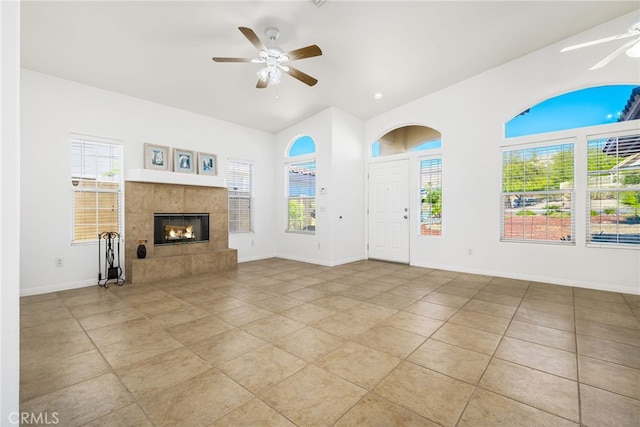 unfurnished living room with a fireplace, light tile patterned floors, and ceiling fan