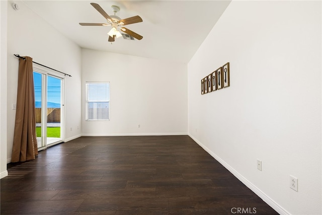 empty room with ceiling fan, dark hardwood / wood-style floors, and lofted ceiling