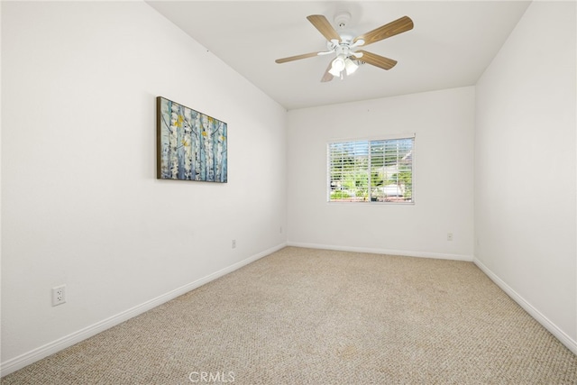 empty room featuring ceiling fan and light colored carpet