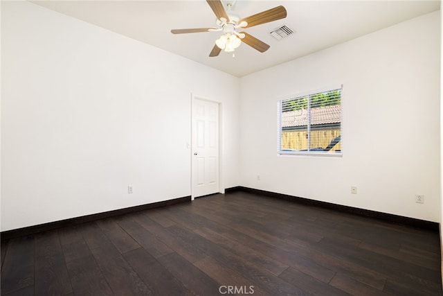 spare room with ceiling fan and dark hardwood / wood-style flooring