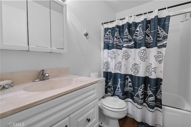 full bathroom with shower / bath combo with shower curtain, vanity, hardwood / wood-style floors, and toilet