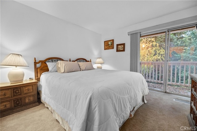 carpeted bedroom featuring access to outside