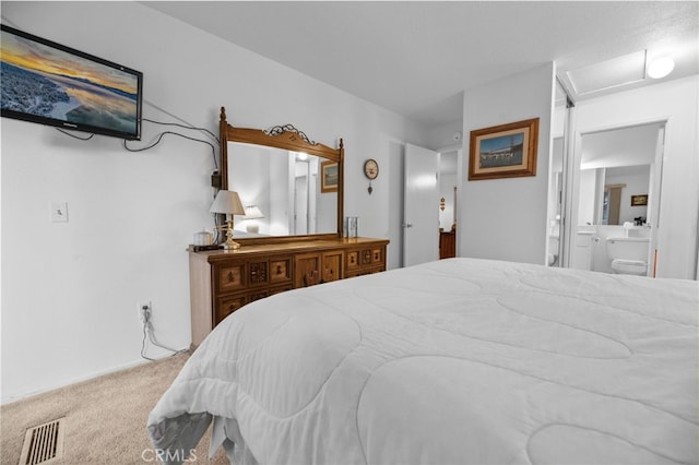 bedroom with carpet and ensuite bath