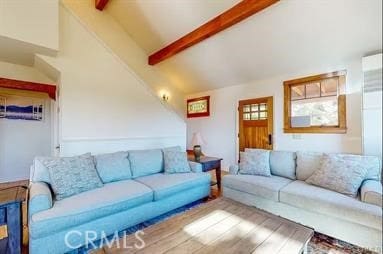 living room with beam ceiling, hardwood / wood-style floors, and high vaulted ceiling