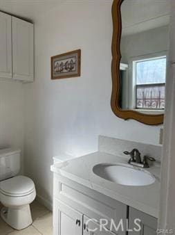 bathroom with tile patterned floors, vanity, and toilet