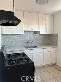 kitchen featuring white cabinets, black range with electric cooktop, light tile patterned flooring, and sink