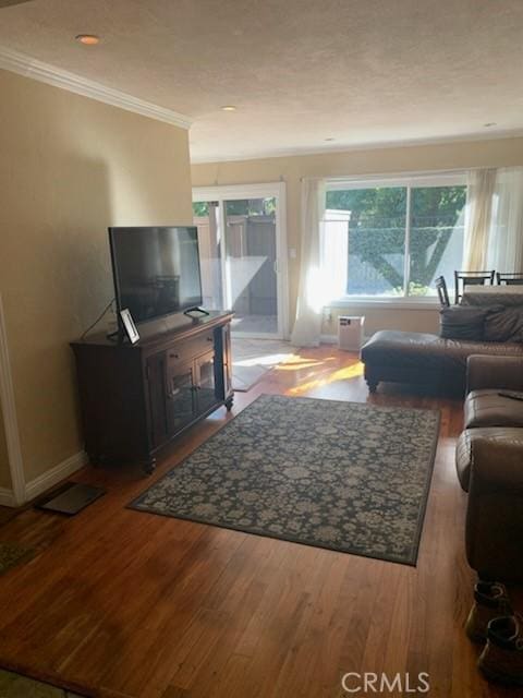 living room with hardwood / wood-style flooring and ornamental molding