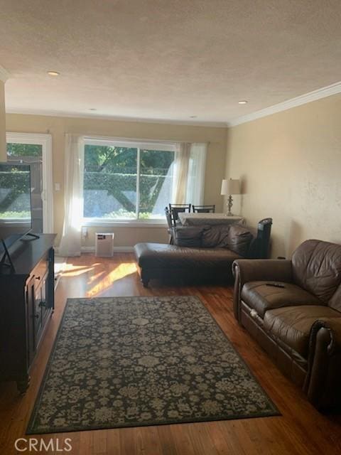 living room featuring hardwood / wood-style floors and crown molding