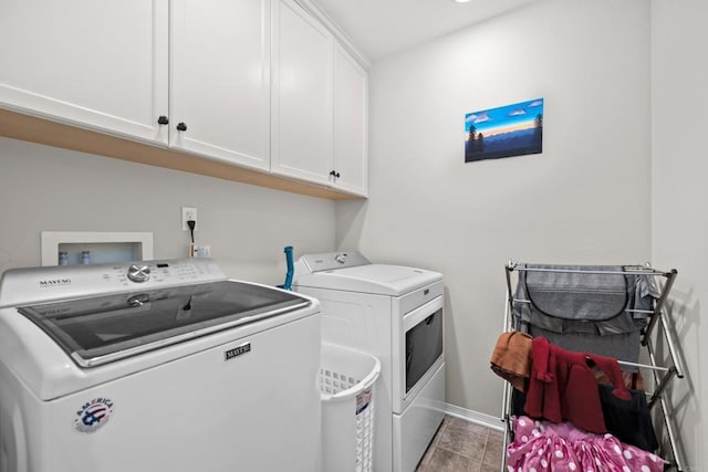 laundry room featuring light tile patterned floors, cabinets, and independent washer and dryer