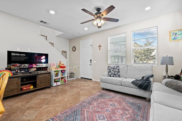 tiled living room with ceiling fan