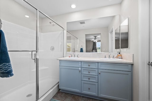 bathroom with tile patterned floors, ceiling fan, an enclosed shower, and vanity