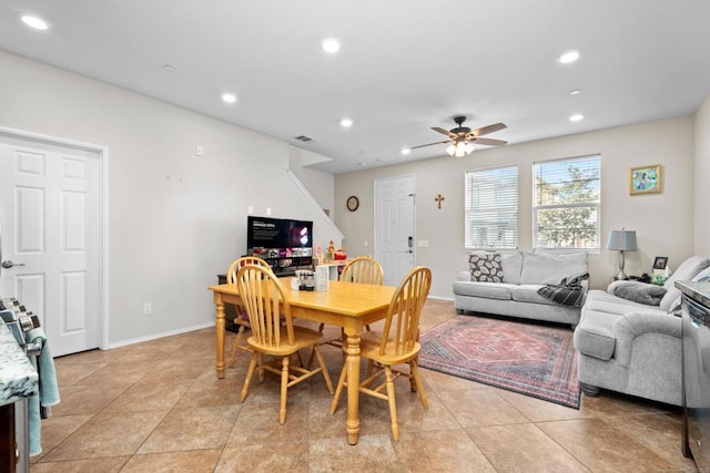 tiled dining space with ceiling fan