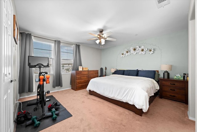 bedroom featuring light colored carpet and ceiling fan