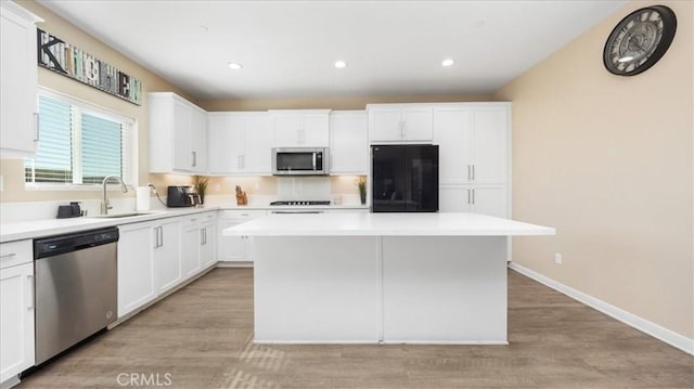 kitchen with a center island, white cabinets, and appliances with stainless steel finishes