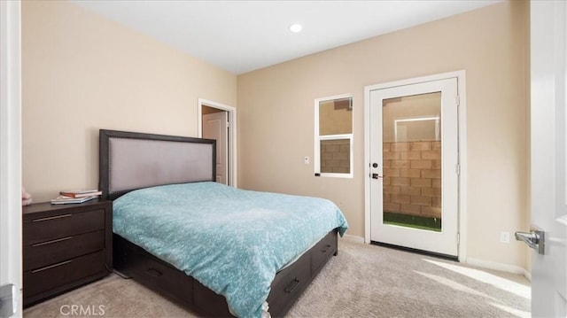 bedroom featuring connected bathroom and light colored carpet