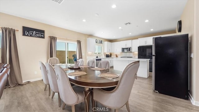 dining area with light hardwood / wood-style flooring