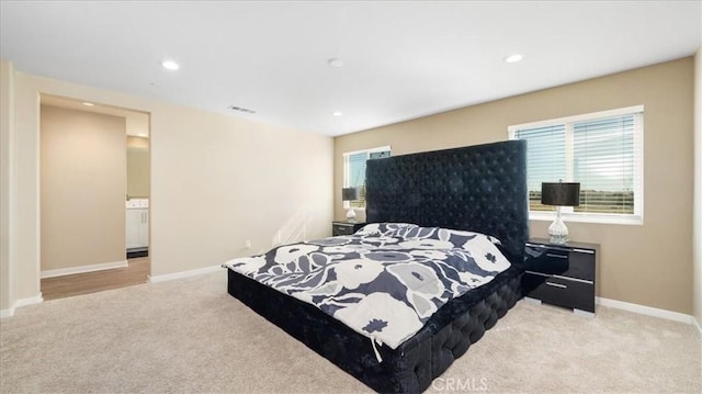 carpeted bedroom with multiple windows