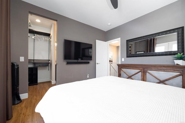 bedroom with ceiling fan, wood-type flooring, and a closet