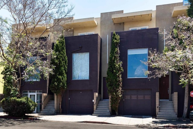 view of front of house featuring stucco siding and an attached garage