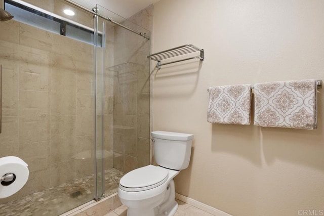 bathroom with an enclosed shower and toilet