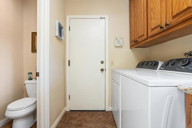 laundry area featuring washing machine and dryer and dark tile patterned floors