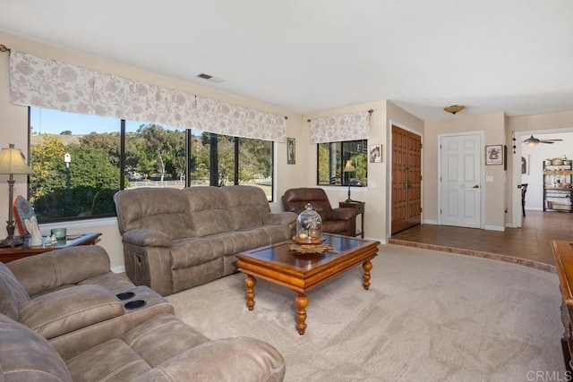 living room with carpet flooring, plenty of natural light, and ceiling fan