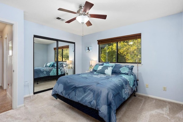 bedroom featuring a closet, ceiling fan, and light colored carpet