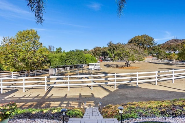 view of yard with a rural view