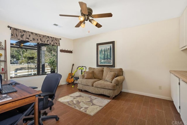 home office featuring ceiling fan and dark wood-type flooring