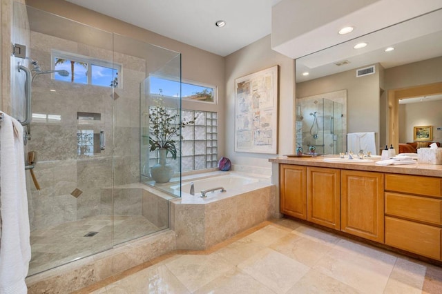 bathroom featuring plus walk in shower and vanity