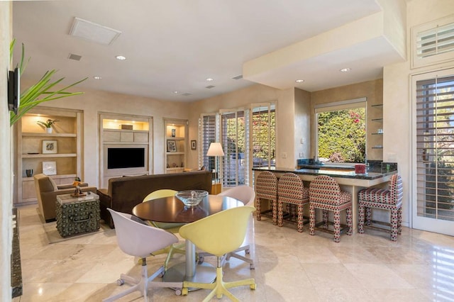 dining area with built in shelves and plenty of natural light