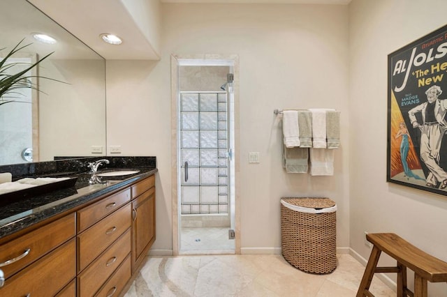 bathroom featuring tile patterned floors, vanity, and a shower with shower door