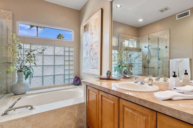 bathroom featuring vanity and plus walk in shower