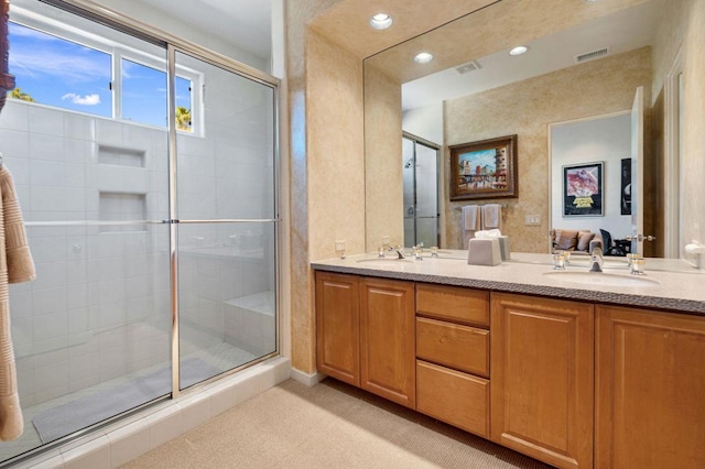 bathroom featuring vanity and a shower with shower door