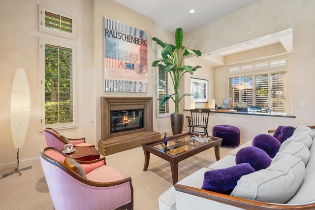 living room featuring a tray ceiling and light colored carpet