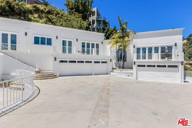 view of front facade with a garage and a balcony