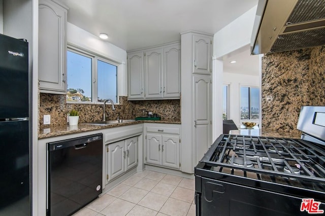 kitchen featuring black appliances, backsplash, sink, and exhaust hood