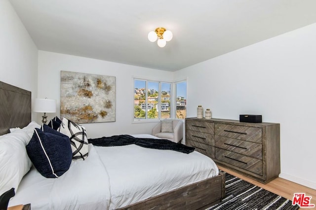 bedroom with wood-type flooring