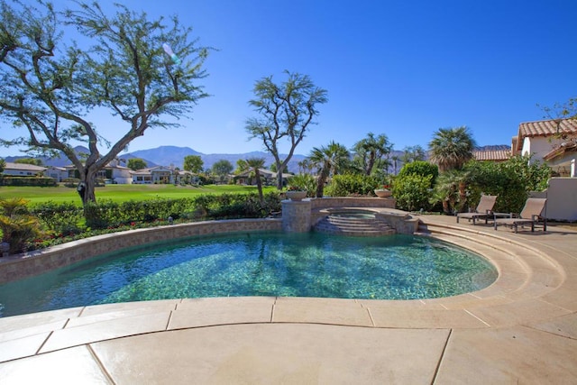 view of swimming pool featuring a mountain view, a patio, and an in ground hot tub