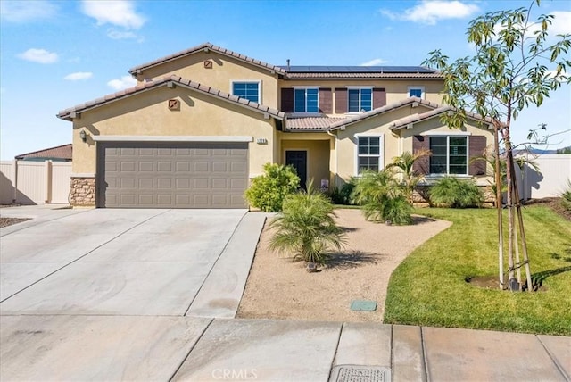 view of front of house featuring solar panels, a garage, and a front yard