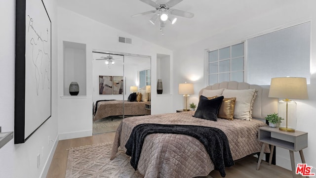 bedroom featuring ceiling fan, light hardwood / wood-style floors, a closet, and vaulted ceiling