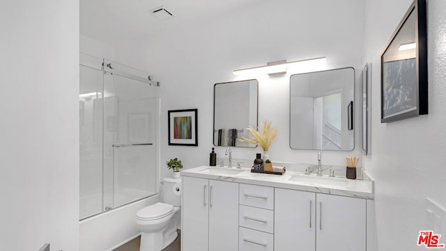 full bathroom featuring vanity, toilet, and enclosed tub / shower combo