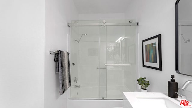 bathroom with vanity and enclosed tub / shower combo