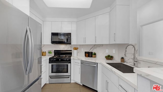 kitchen with white cabinetry, sink, and stainless steel appliances