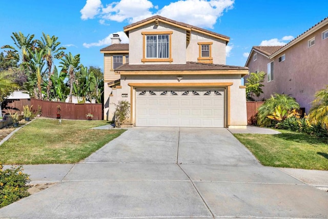 view of front of house featuring a garage and a front lawn