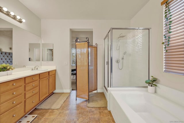 bathroom with tile patterned floors, vanity, and independent shower and bath